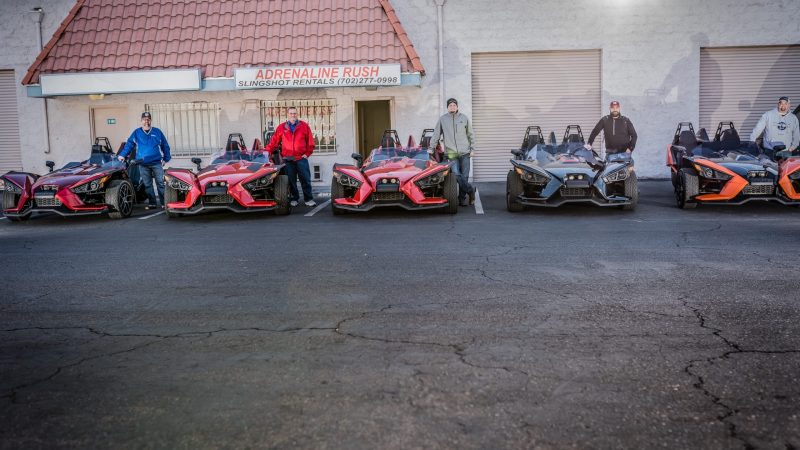 a row of parked motorcycles sitting on the side of a building