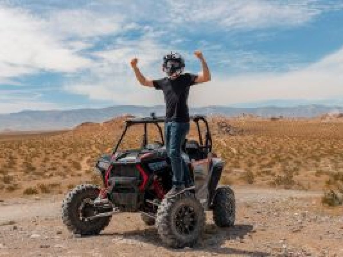 a man riding a bike down a dirt road