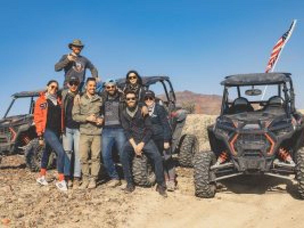 a group of people riding on the back of a truck