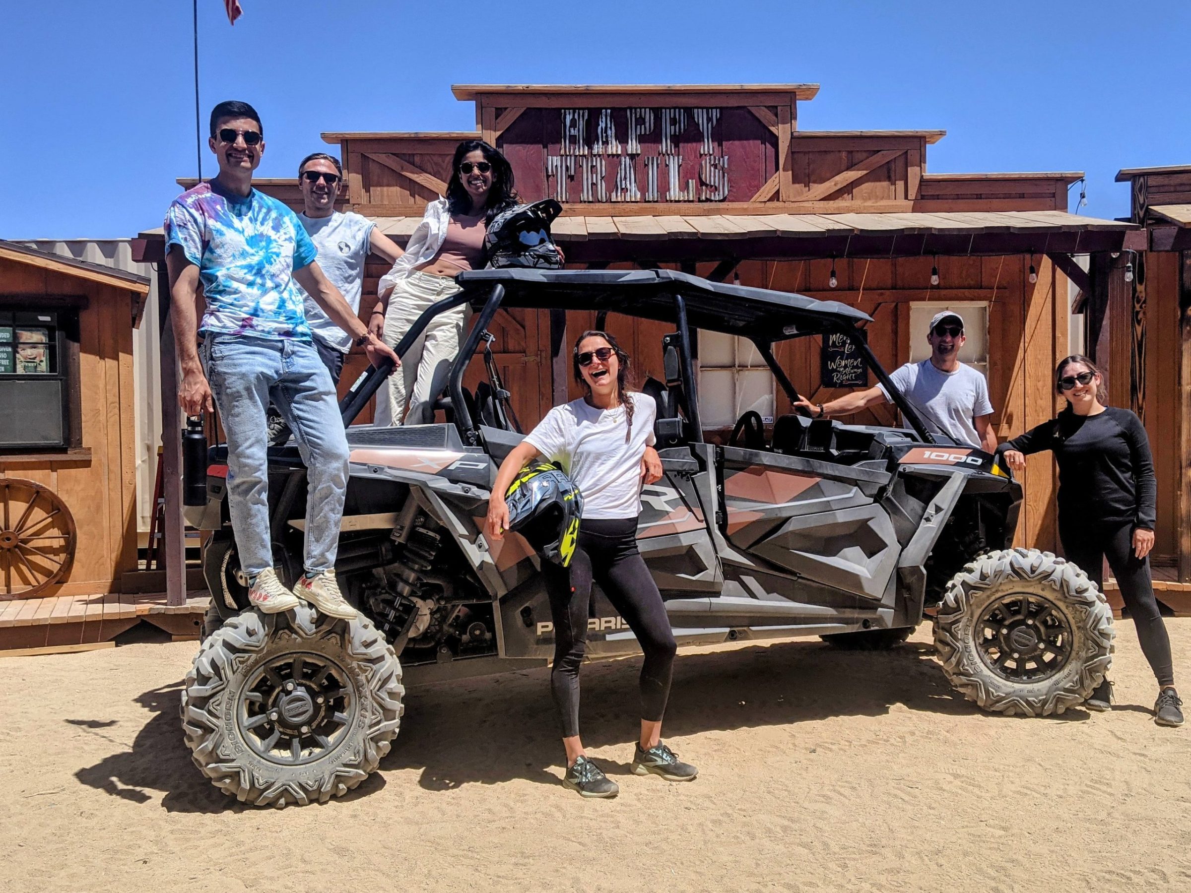 a group of people standing around a motorcycle in front of a building